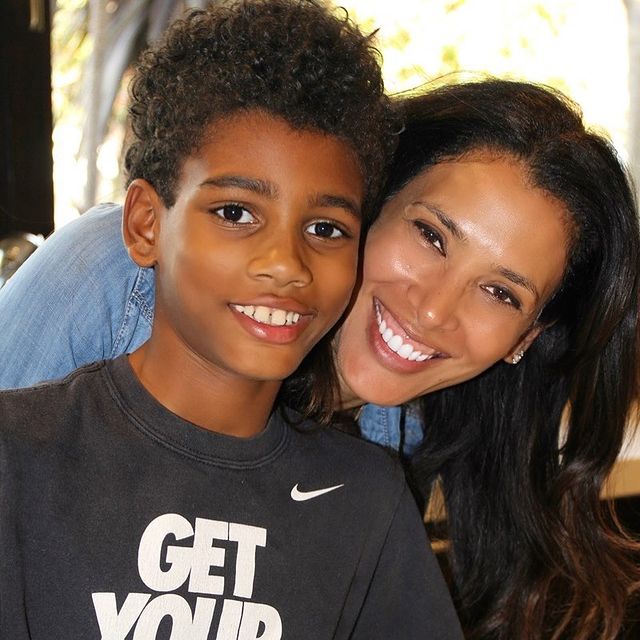Kristen Baker Bellamy in a blue tops with her son in a black t-shirt.